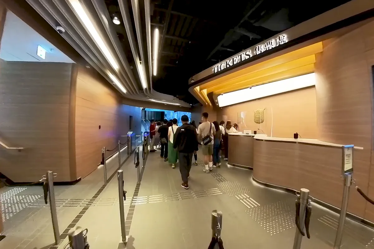 The ticket hall at the Central Terminus of the Peak Tram after the 2022 renovation, with a long ticket counter and queue rails