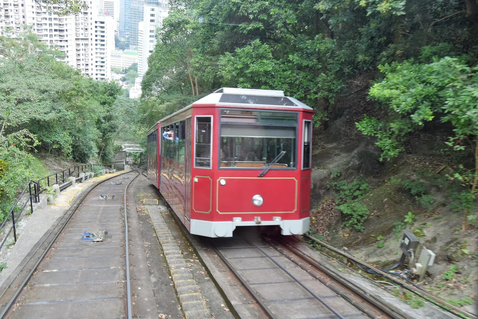 An earlier-generation red tram at the passing loop, photographed before the 2022 upgrade